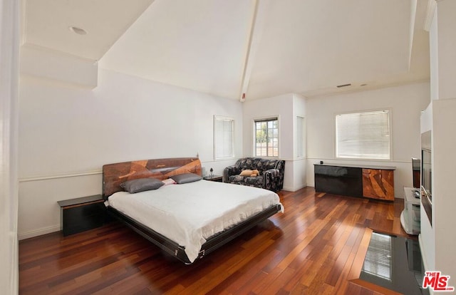 bedroom with vaulted ceiling with beams and dark hardwood / wood-style floors