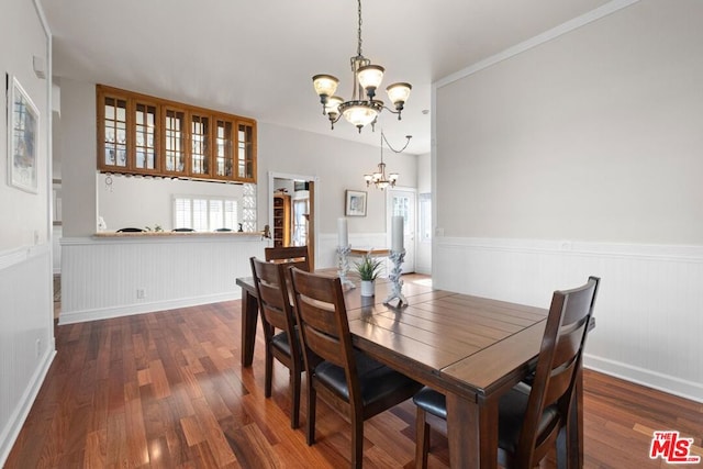 dining area featuring dark hardwood / wood-style floors and a chandelier