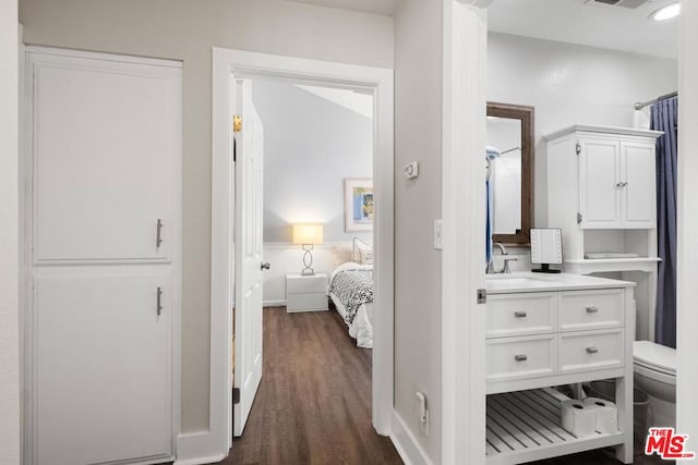 corridor with sink and dark hardwood / wood-style floors