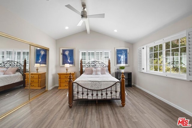 bedroom featuring hardwood / wood-style floors, lofted ceiling with beams, a closet, and ceiling fan