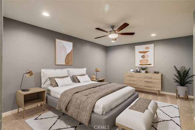 bedroom with ceiling fan and light carpet