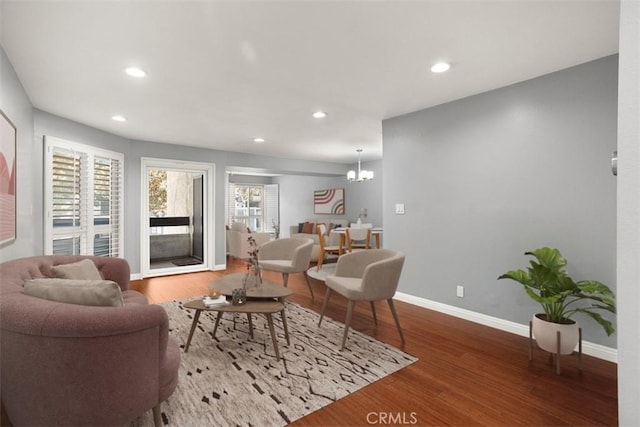 living room with a notable chandelier and hardwood / wood-style floors