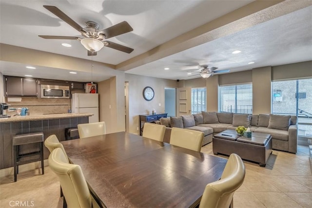 dining area with ceiling fan and light tile patterned floors