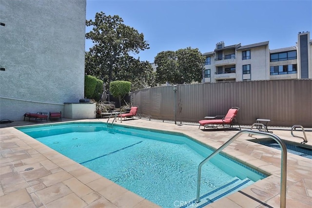 view of swimming pool with a patio area