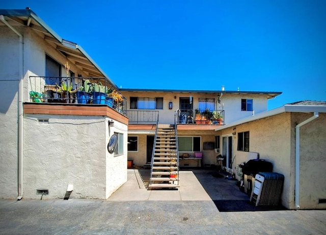 exterior space featuring a patio and a balcony