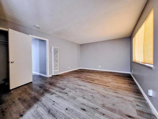 unfurnished bedroom featuring wood-type flooring and a textured ceiling