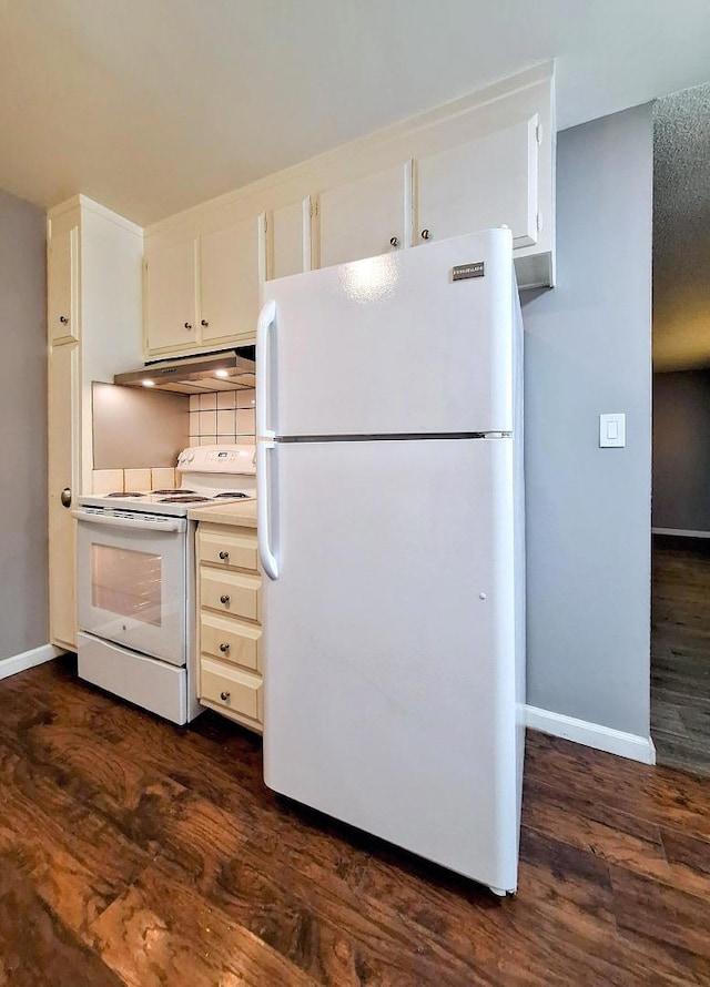 kitchen featuring dark wood-type flooring, white appliances, tasteful backsplash, and white cabinets