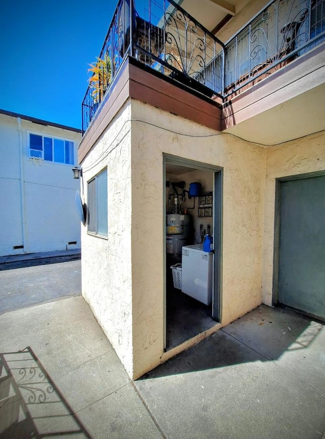 view of side of home featuring secured water heater