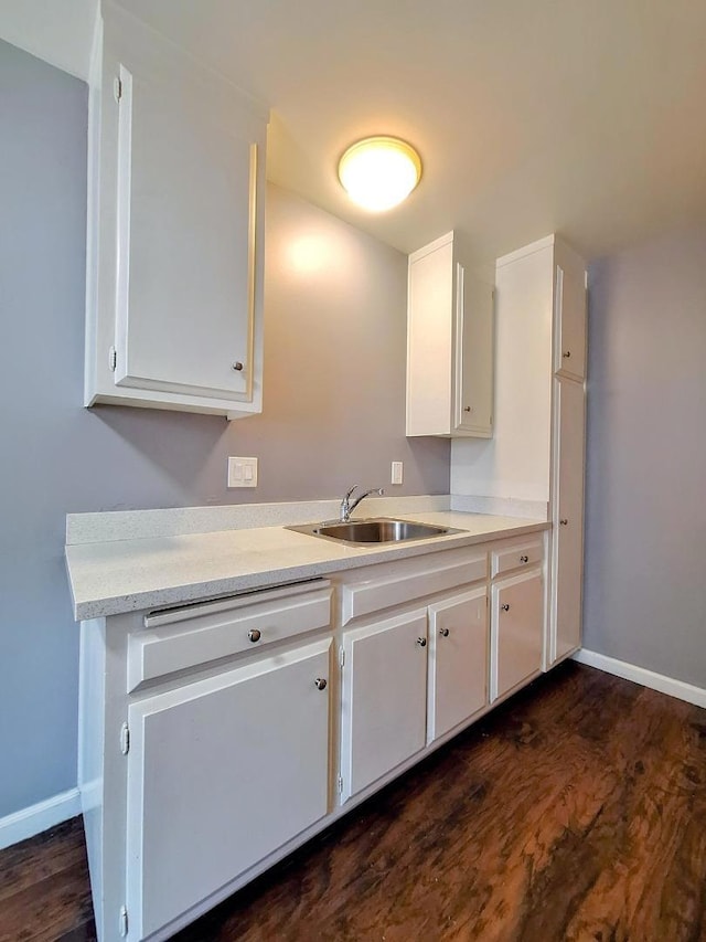 kitchen featuring sink, white cabinets, and dark hardwood / wood-style floors