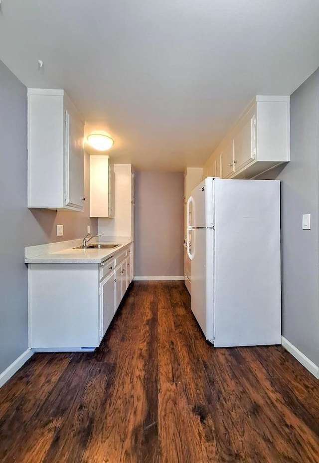 kitchen with white refrigerator, white cabinetry, sink, and dark hardwood / wood-style flooring