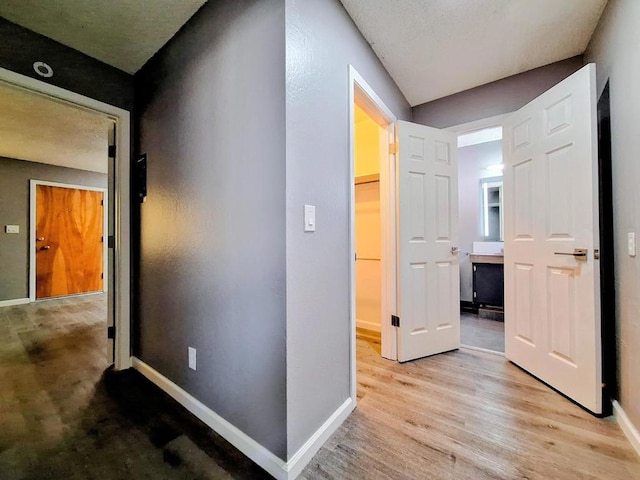 corridor with light hardwood / wood-style flooring