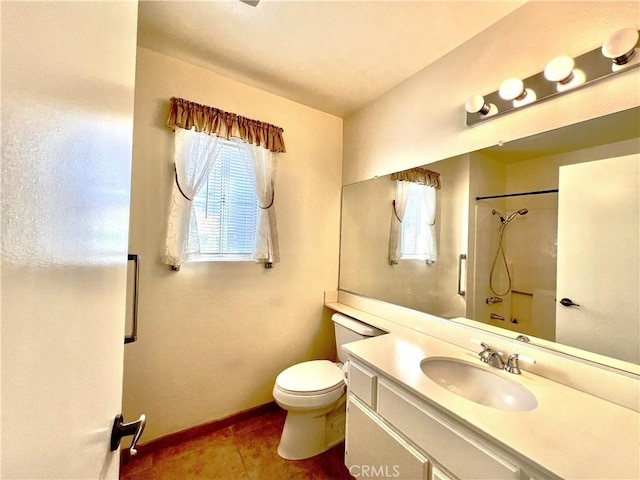 bathroom with vanity, toilet, tile patterned flooring, and a shower