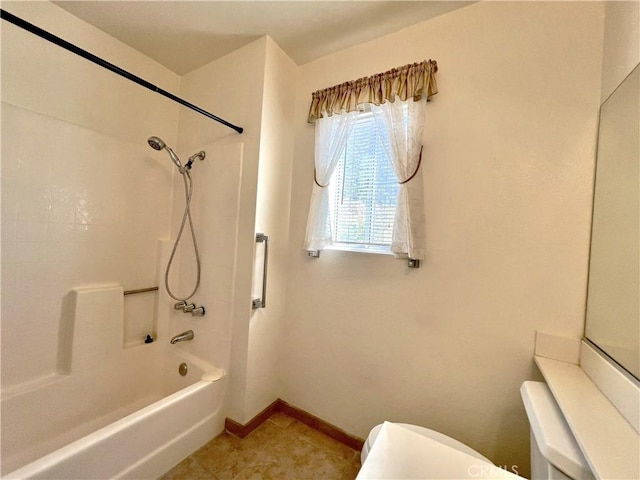 bathroom with tile patterned floors, shower / washtub combination, and toilet