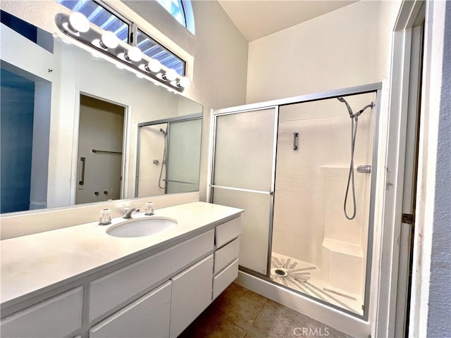 bathroom featuring vanity, tile patterned floors, and walk in shower