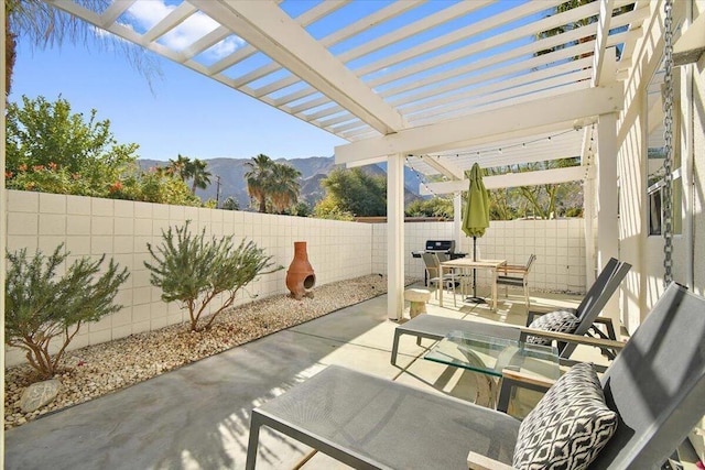 view of patio / terrace featuring a mountain view and a pergola