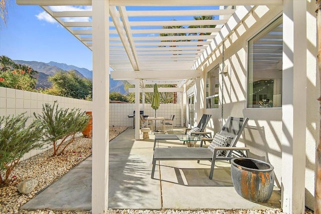 view of patio with a mountain view and a pergola