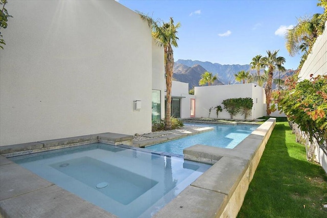 view of pool featuring an in ground hot tub and a mountain view