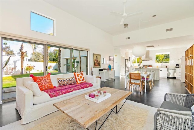 living room with ceiling fan and a healthy amount of sunlight