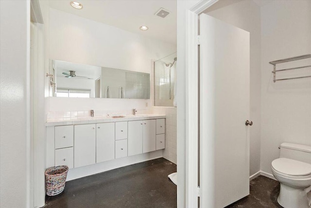 bathroom featuring a shower, toilet, ceiling fan, and vanity