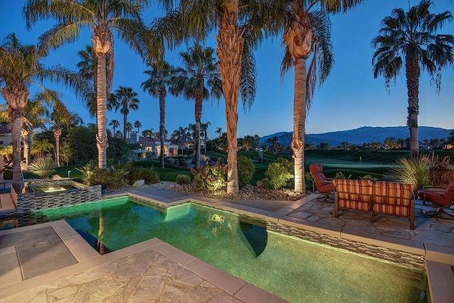 view of pool featuring a jacuzzi, a mountain view, and a patio