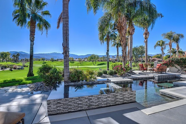 view of pool with a mountain view, a patio area, and a yard