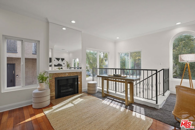 sitting room featuring wood-type flooring and ornamental molding