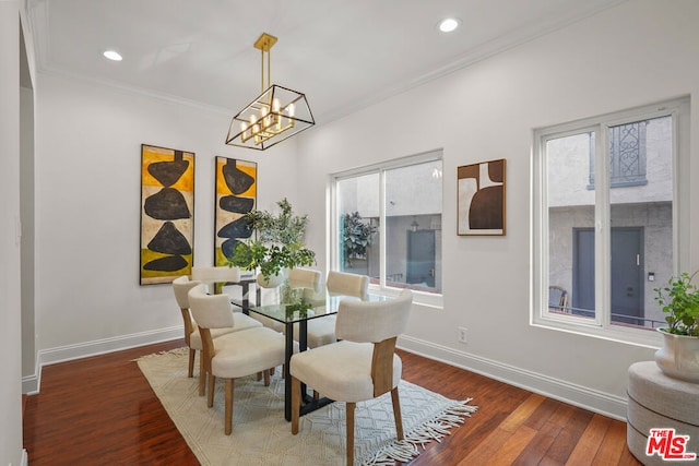 dining room with crown molding, plenty of natural light, a notable chandelier, and dark hardwood / wood-style flooring