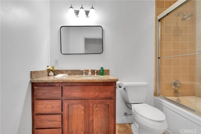 full bathroom with vanity, toilet, and bath / shower combo with glass door