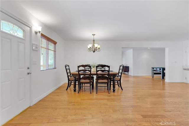 dining space with an inviting chandelier and light wood-type flooring