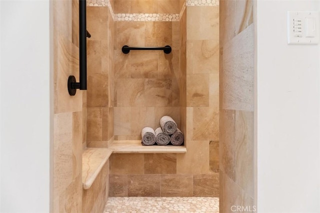 bathroom with a tile shower