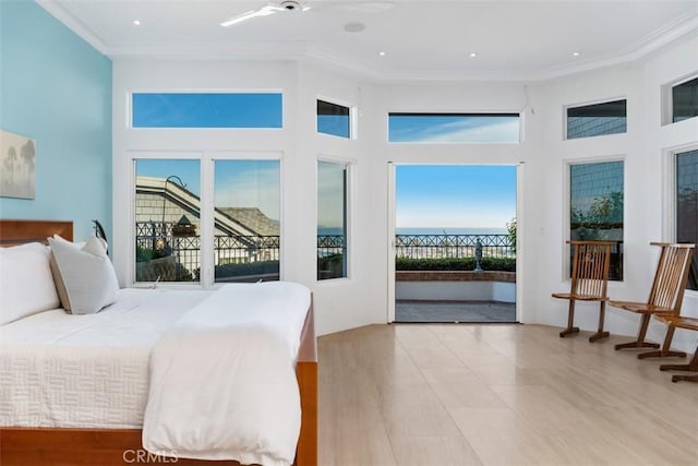 bedroom featuring ceiling fan, crown molding, and access to outside