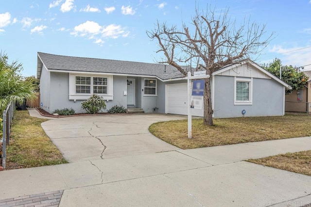 ranch-style house featuring a garage and a front yard