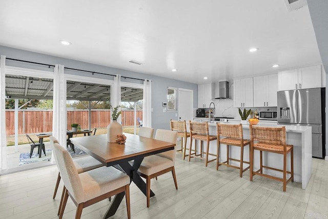 dining space featuring light wood-type flooring