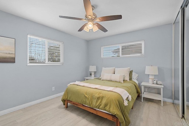 bedroom with ceiling fan and light wood-type flooring