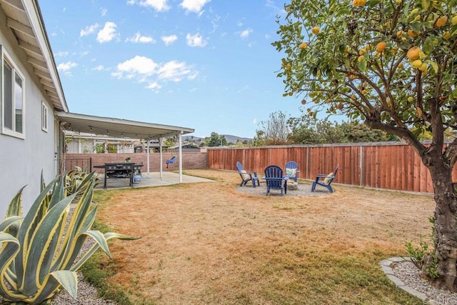 view of yard featuring a patio area and a fire pit