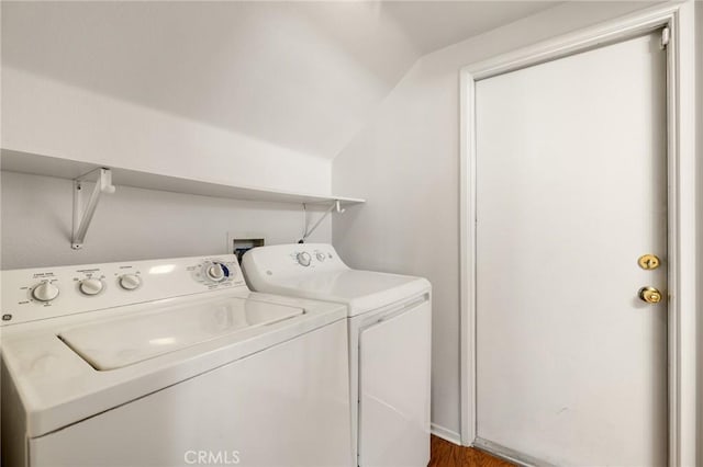 clothes washing area with dark hardwood / wood-style floors and independent washer and dryer