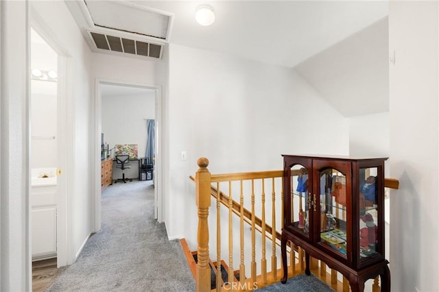 hall with light colored carpet and lofted ceiling