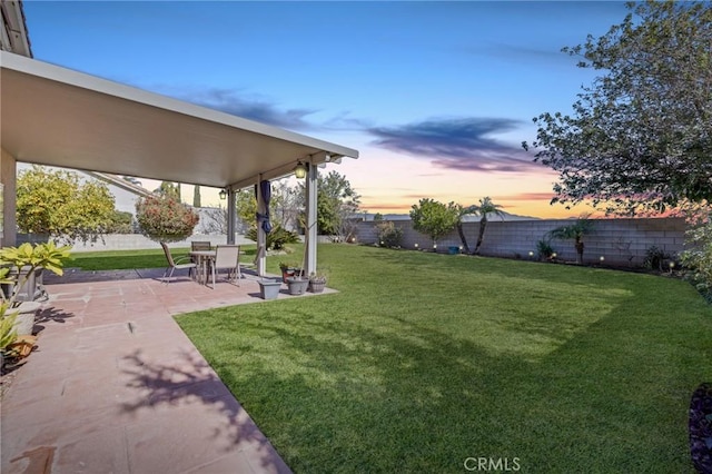 yard at dusk with a patio