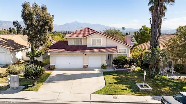 view of front of house with a garage, a mountain view, and a front yard