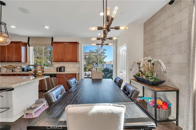 dining space featuring a chandelier and dark wood-type flooring