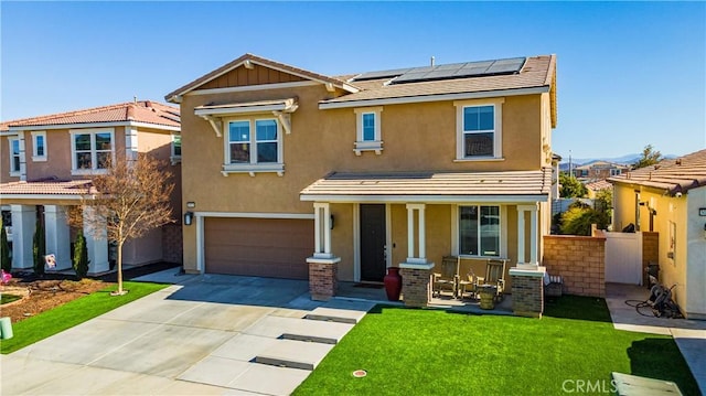 view of front of home with a porch, a garage, solar panels, and a front yard