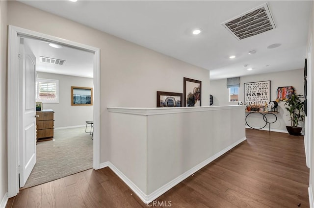 hallway with hardwood / wood-style flooring