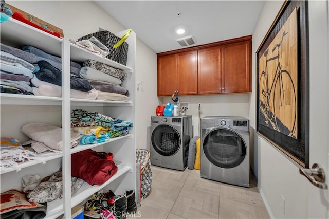 laundry room featuring cabinets and washer and dryer