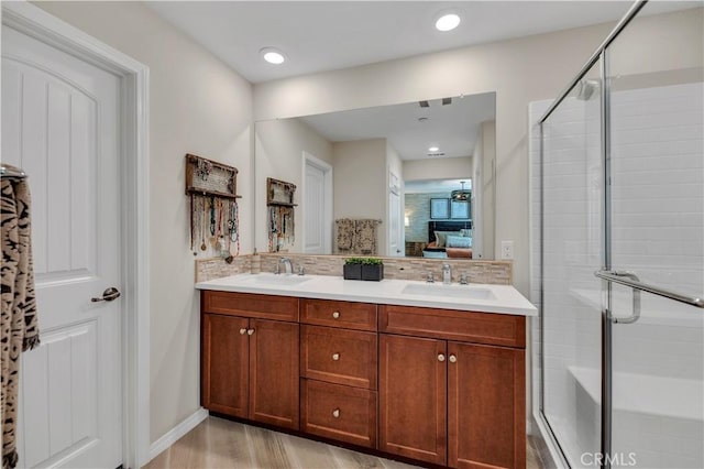 bathroom with hardwood / wood-style floors, backsplash, a shower with door, and vanity