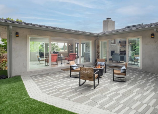 view of patio / terrace featuring an outdoor living space with a fire pit