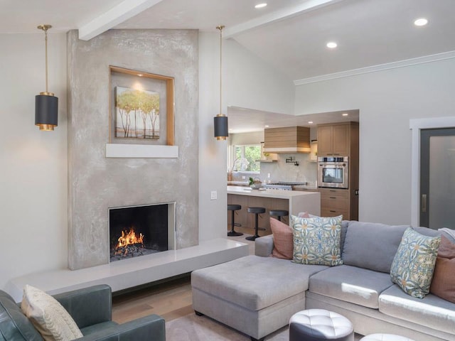 living room featuring a high end fireplace, crown molding, light hardwood / wood-style floors, and lofted ceiling with beams