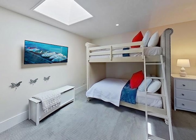 bedroom with carpet floors and a skylight