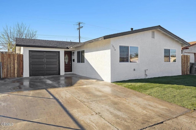 ranch-style home featuring a front yard and a garage