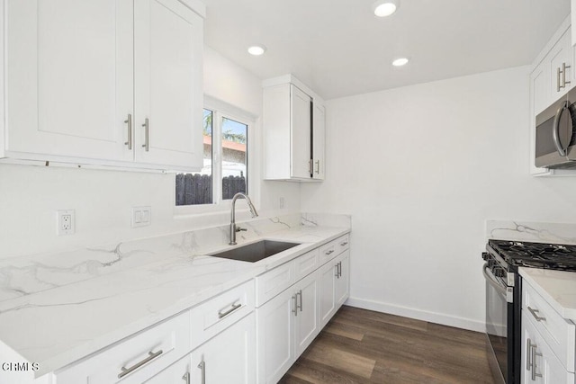 kitchen featuring sink, light stone counters, white cabinets, and stainless steel appliances