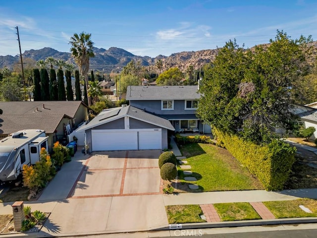 view of property featuring a mountain view and a front yard